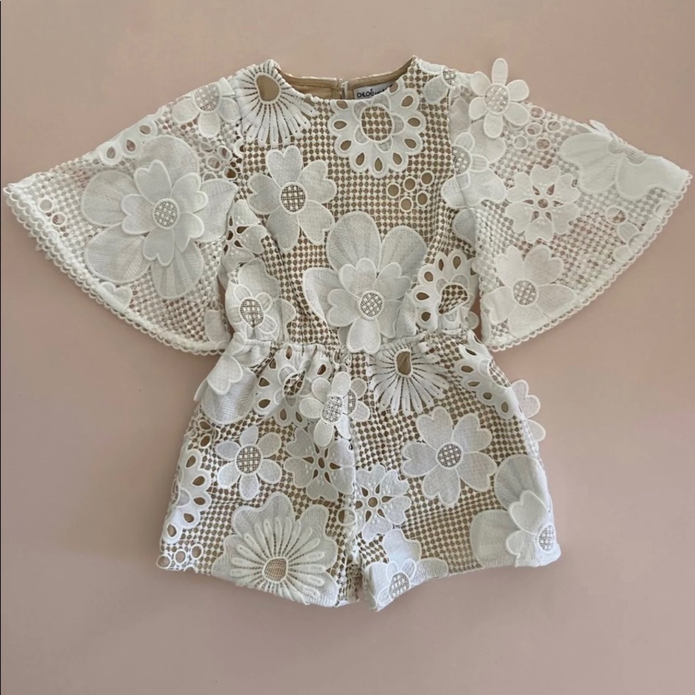 Never worn with tags. White lace flower girl jumpsuit from Chloé and Amélie